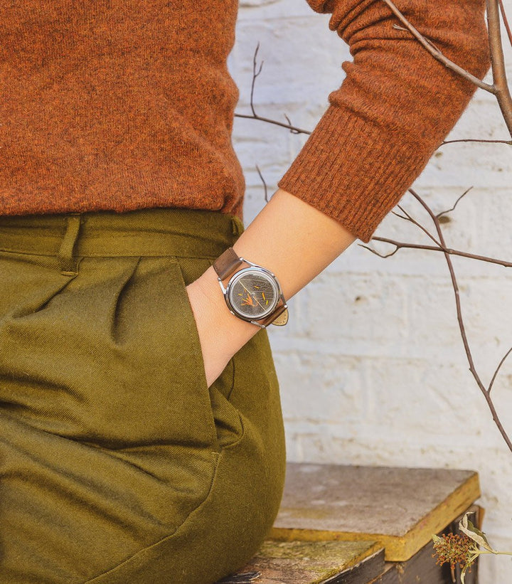 Autumn's riches on wrist with hand in pocket