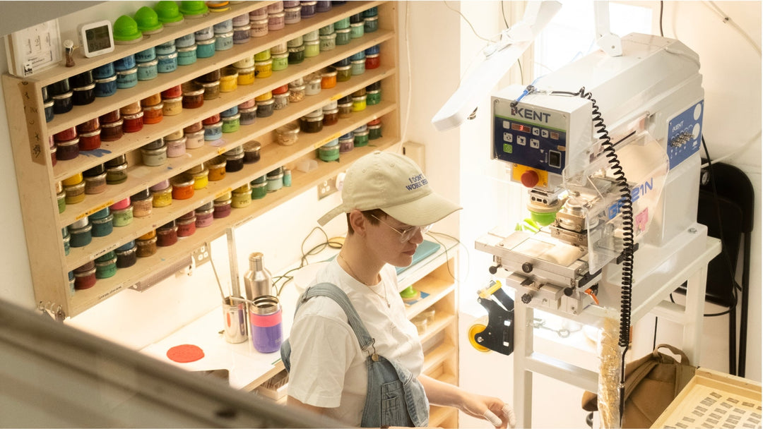 Workshop technician in print workshop next to ink pots