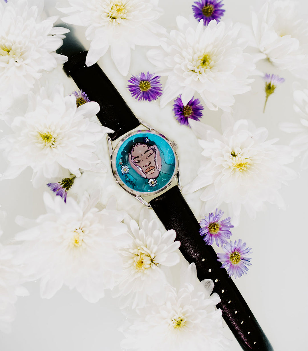 Ophelia watch in milk bath surrounded by flowers